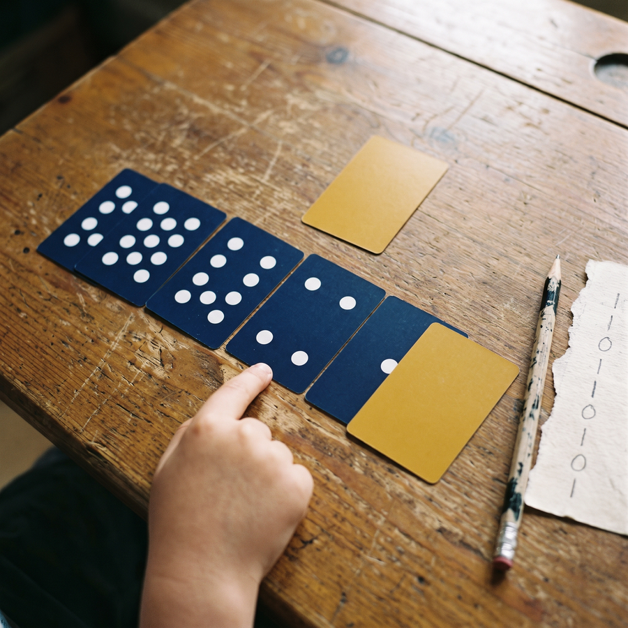 Binary dot cards in a row, some face up and some face down, making a number